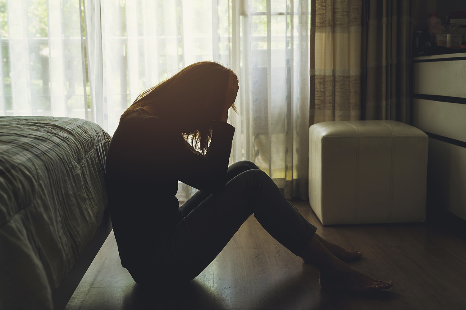 woman sitting with her hands on her head