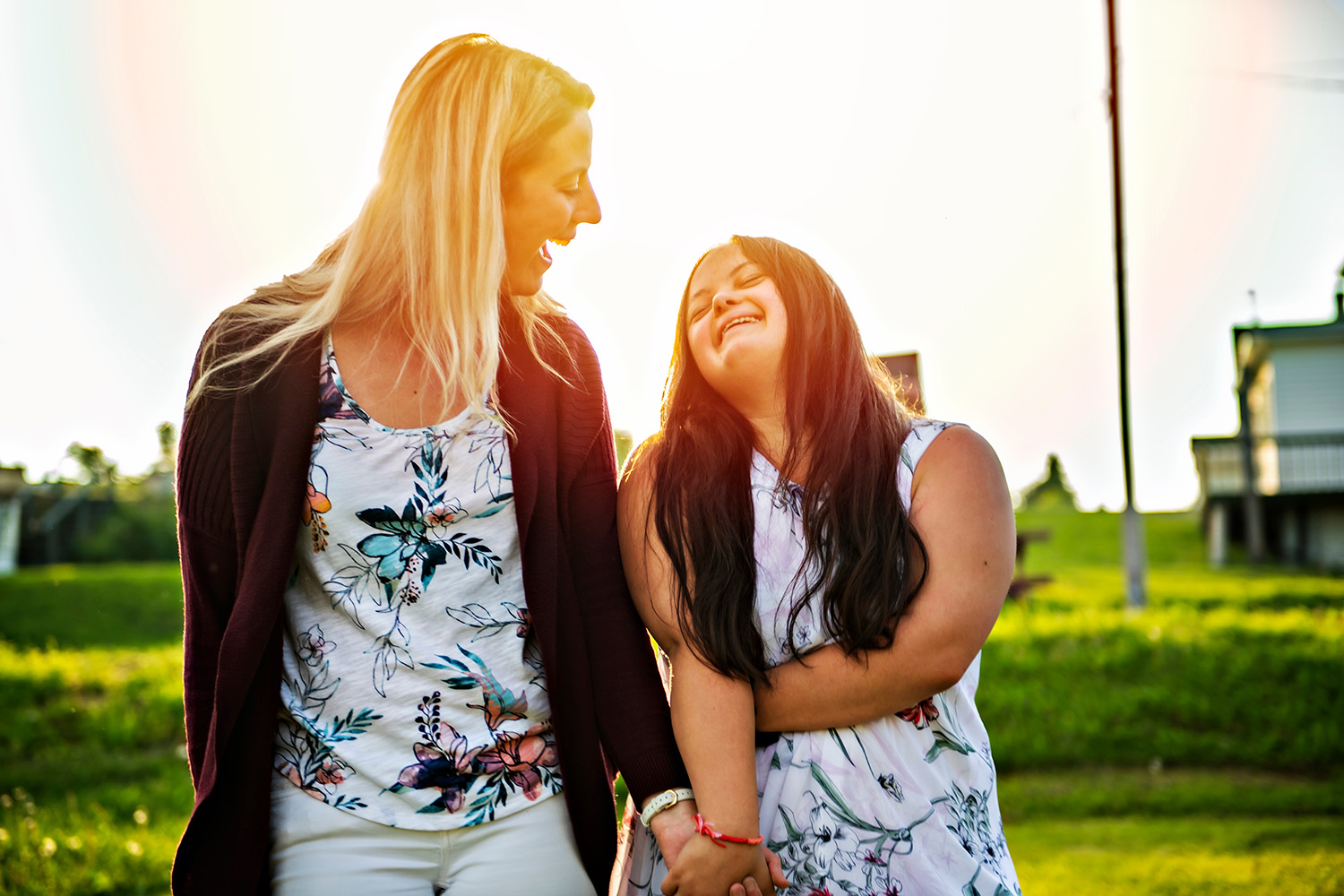 Teen girl with disabilties and woman walking in a park